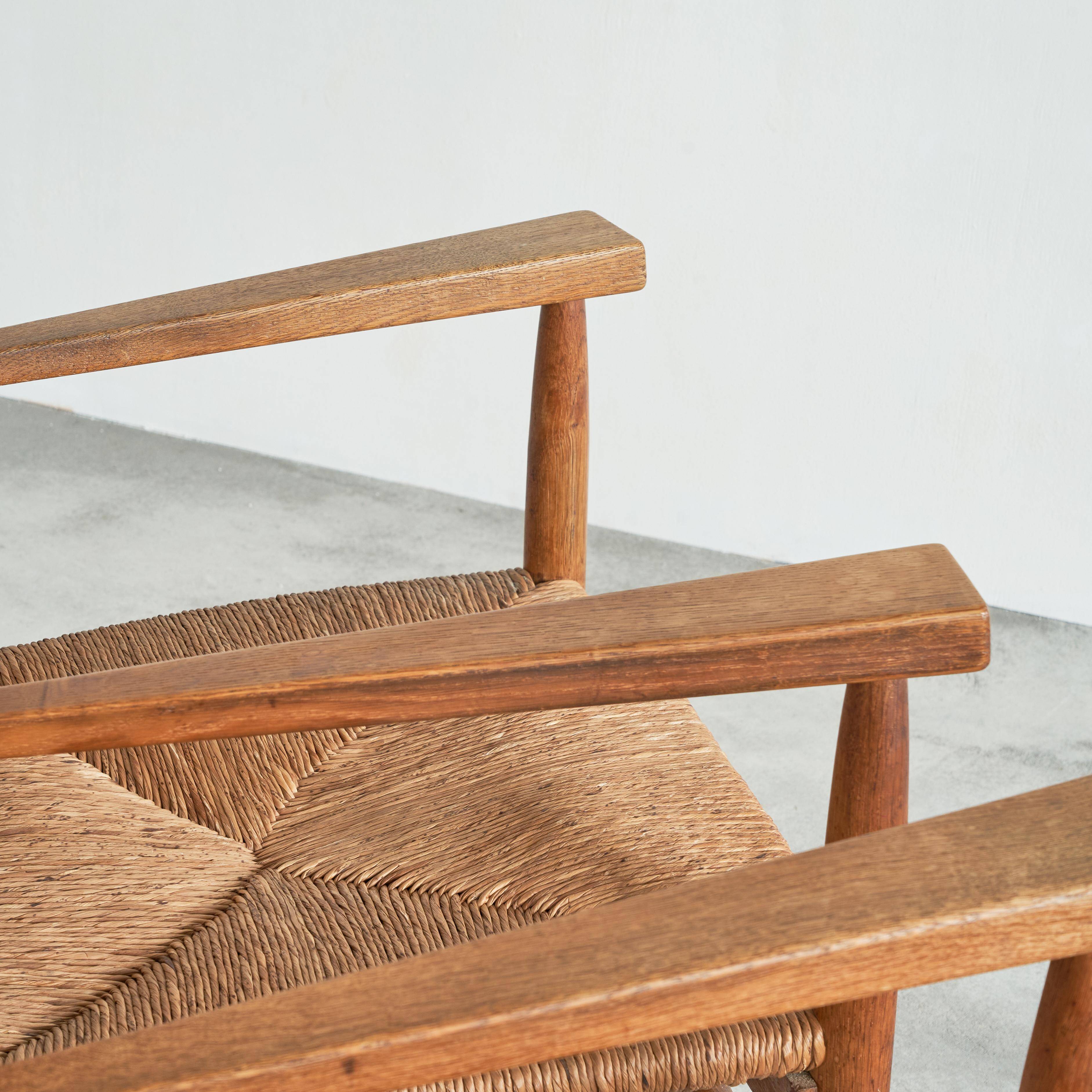 Set of 2 oak and wicker armchairs, mid-20th century.