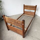 Brutalist style bed with chain and straw