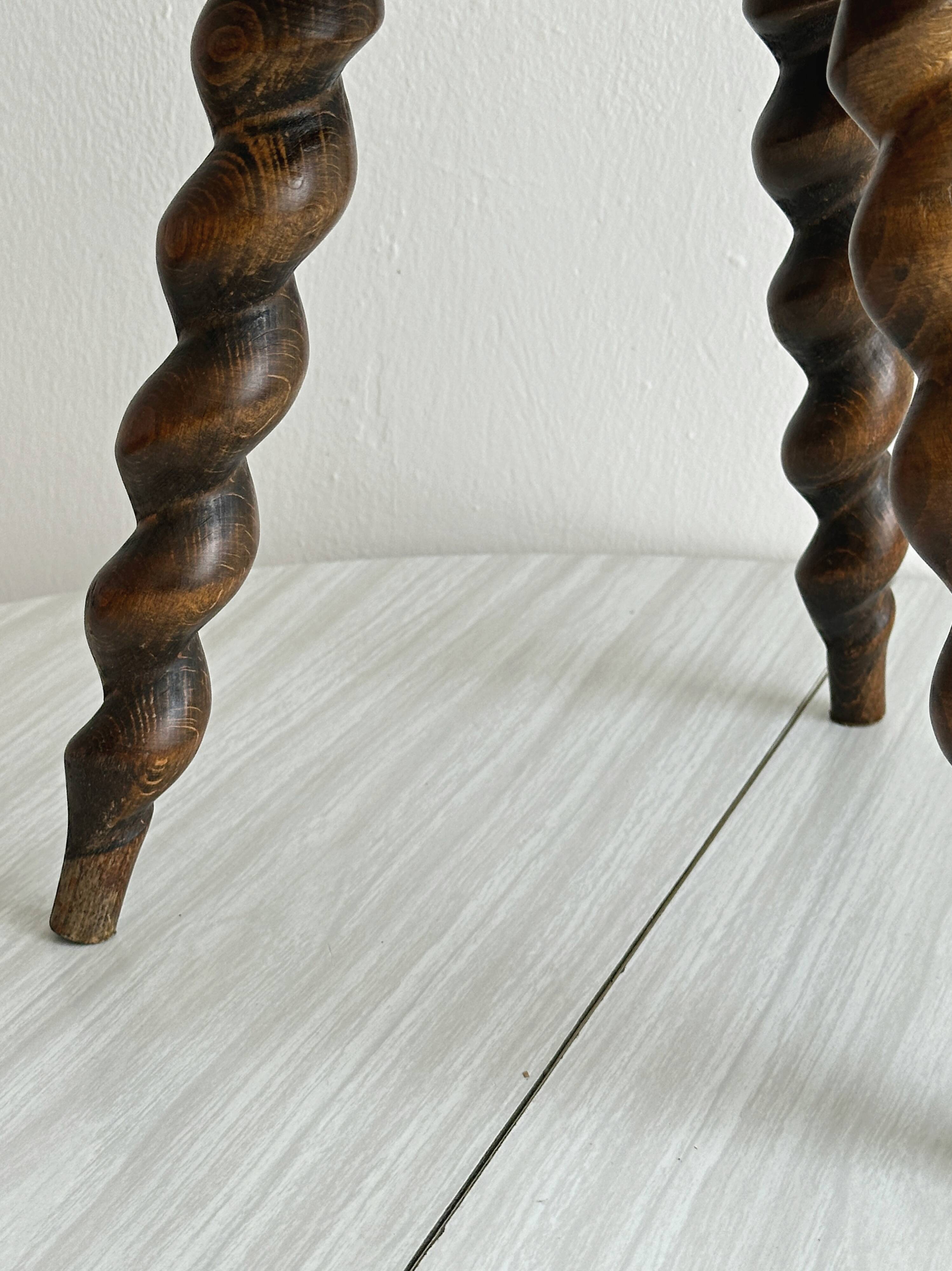 Small antique tripod stool in dark wood.