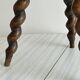 Small antique tripod stool in dark wood.