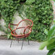 Rattan shell armchair with metal feet