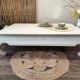 Exotic wood coffee table with its safety glass protection.