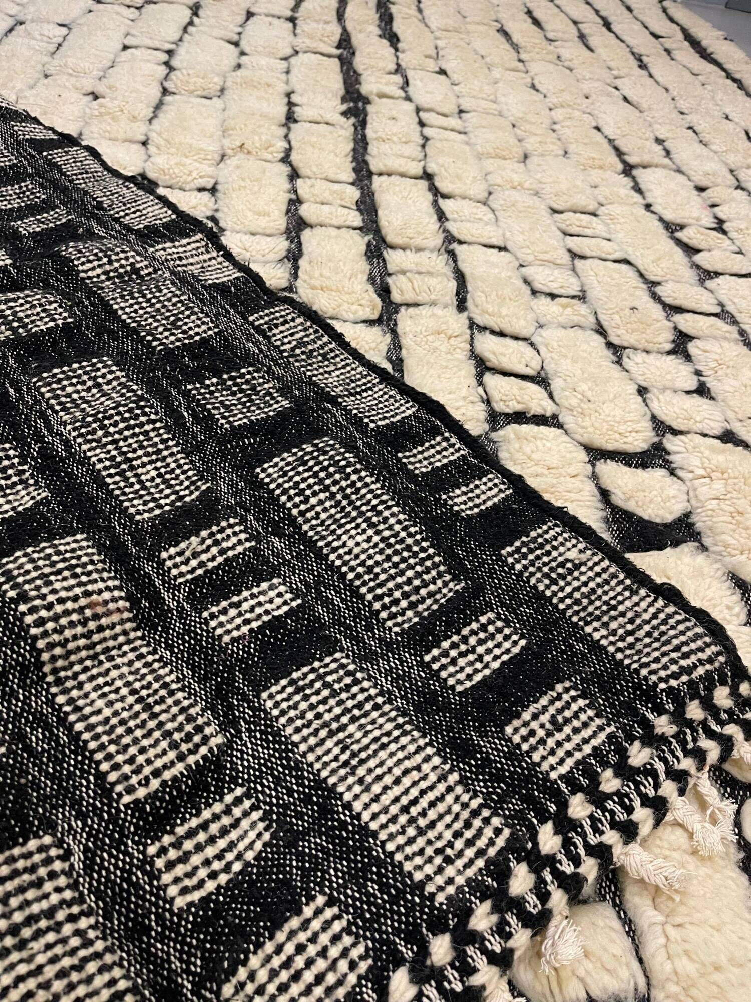 Large cream and black checked Berber rug, 280 × 200 cm.