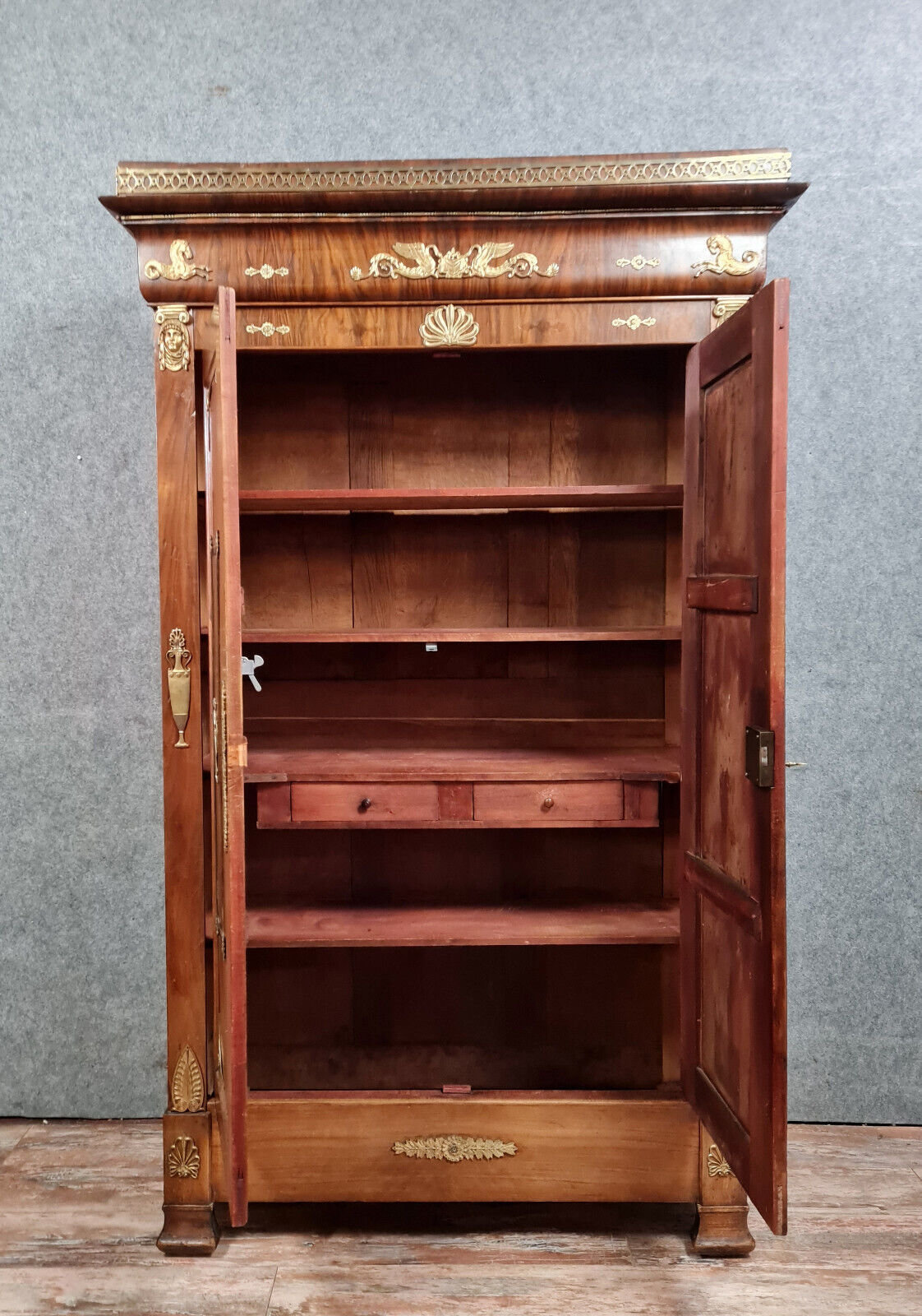 Louis Philippe period wardrobe (nineteenth) entirely covered with gilded bronzes