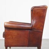 English style sheepskin leather wingback chair in a cognac color