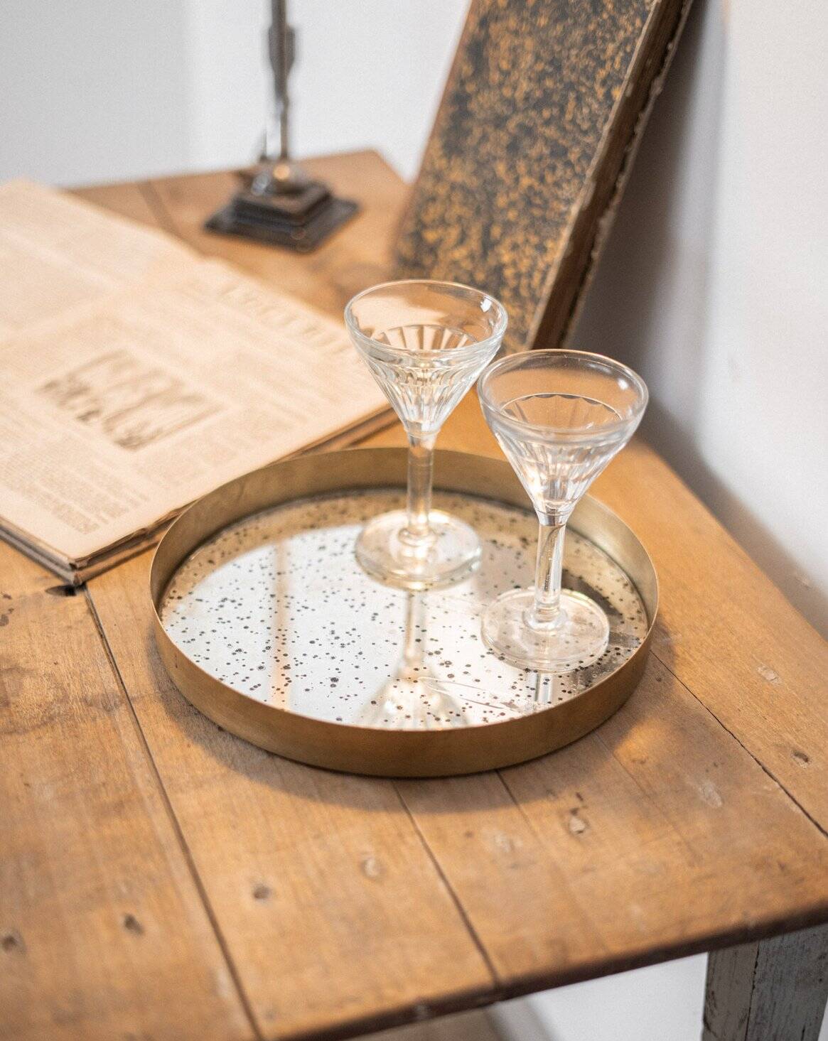 Patinated mirrored top and brass