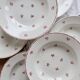 6 vintage white earthenware deep plates with red patterns