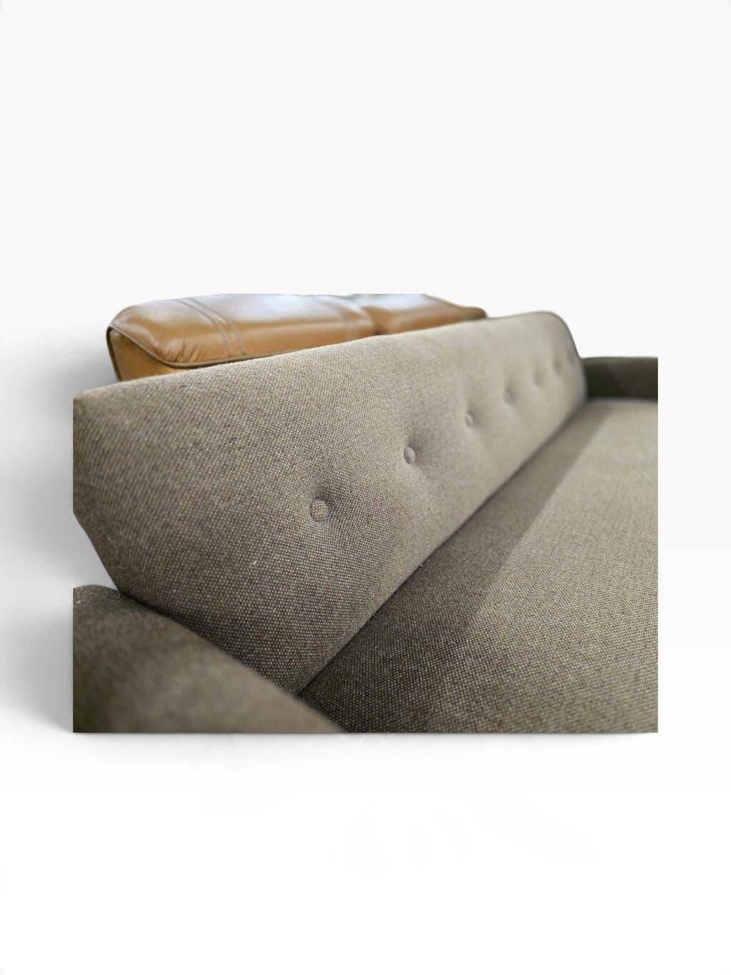 Vintage armchair/sofa/lounge in taupe colour with a stain.