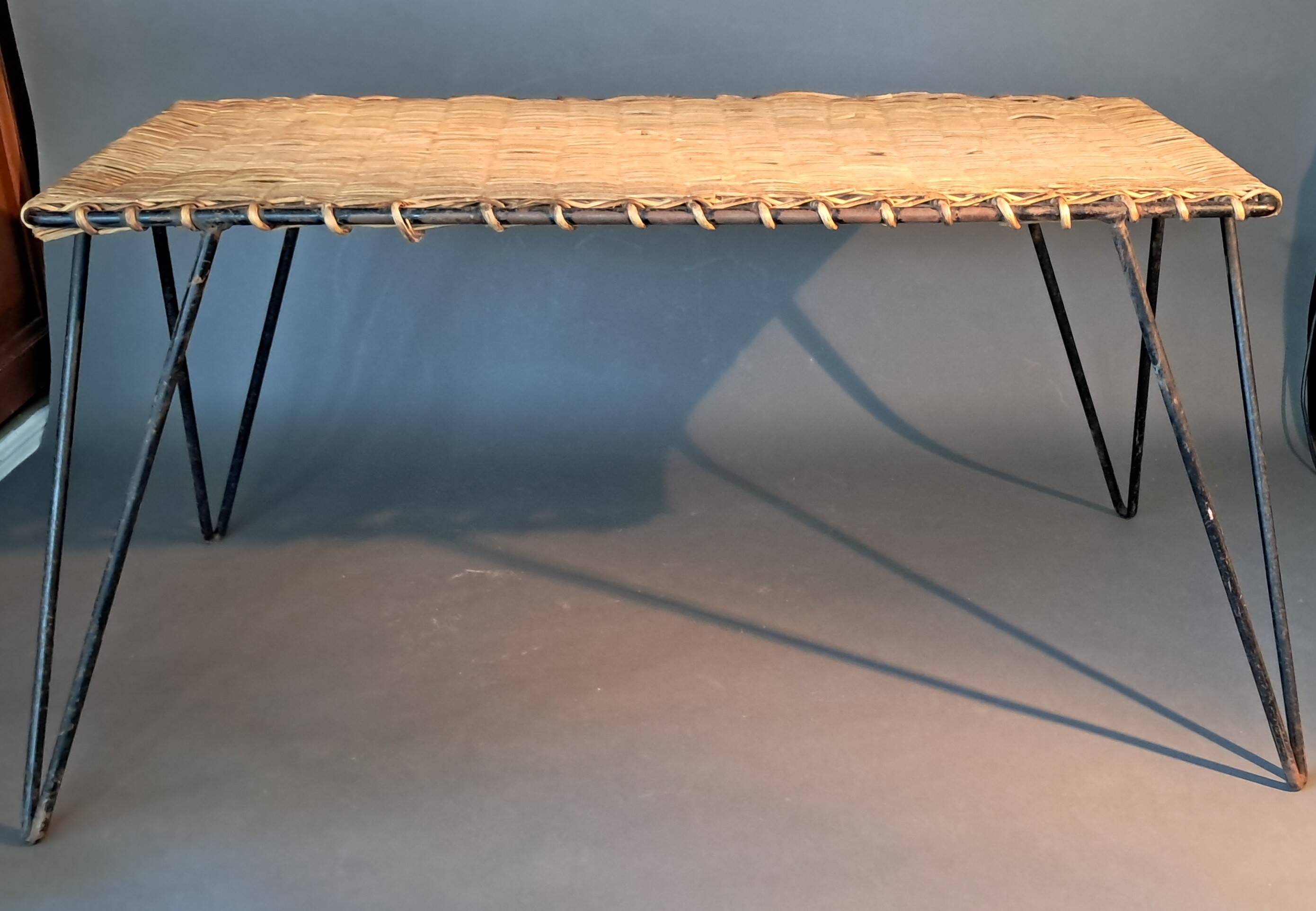 Vintage Raoul Guys coffee table in wicker and black metal, 1960.