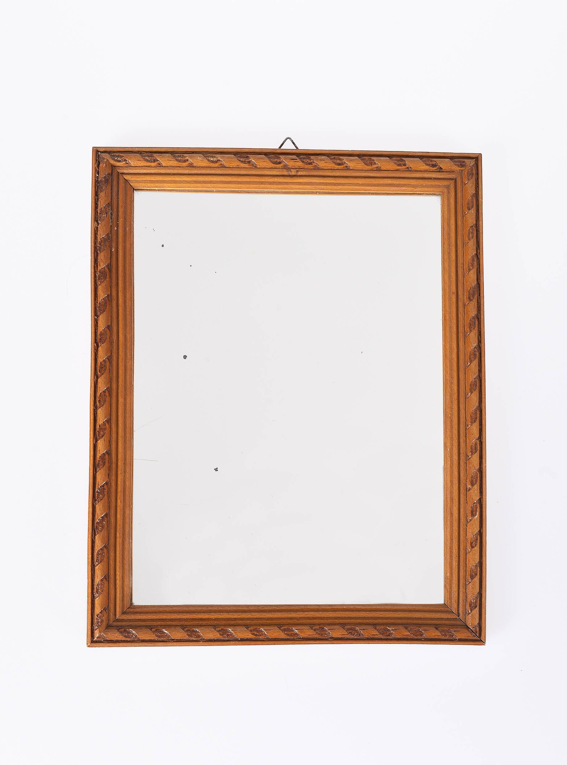 Small old wooden mirror with carved frame