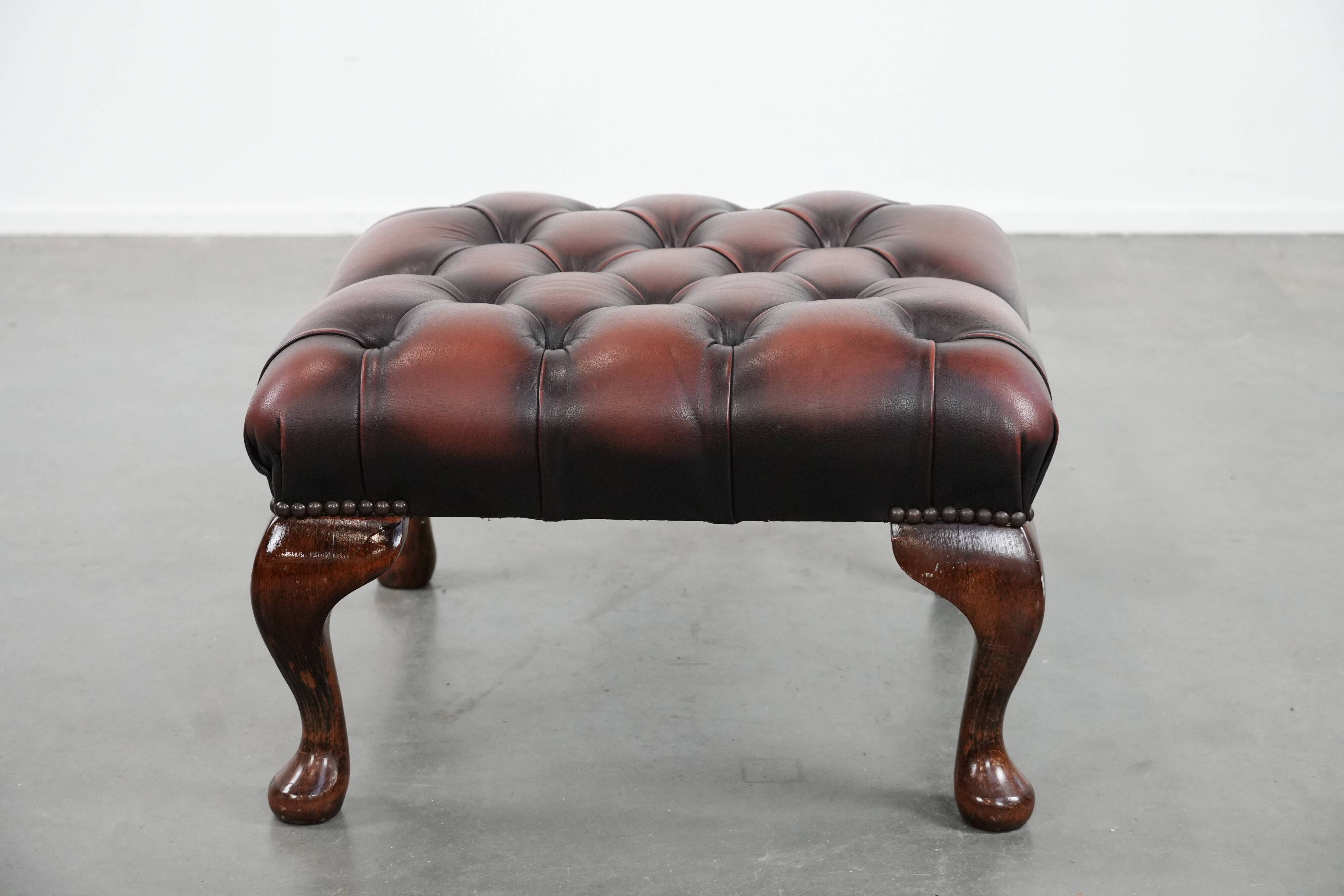 Dark brown chesterfield ottoman in cowhide leather