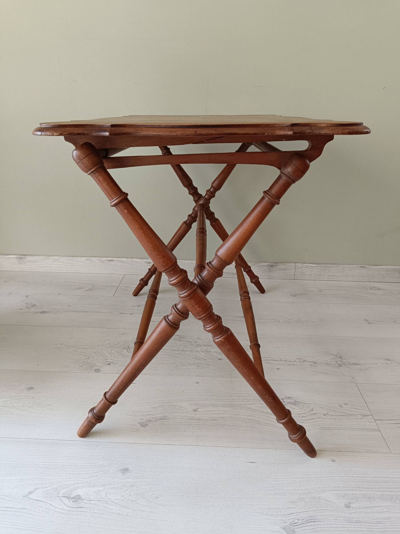 Vintage folding table with turned legs.