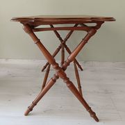 Vintage folding table with turned legs.