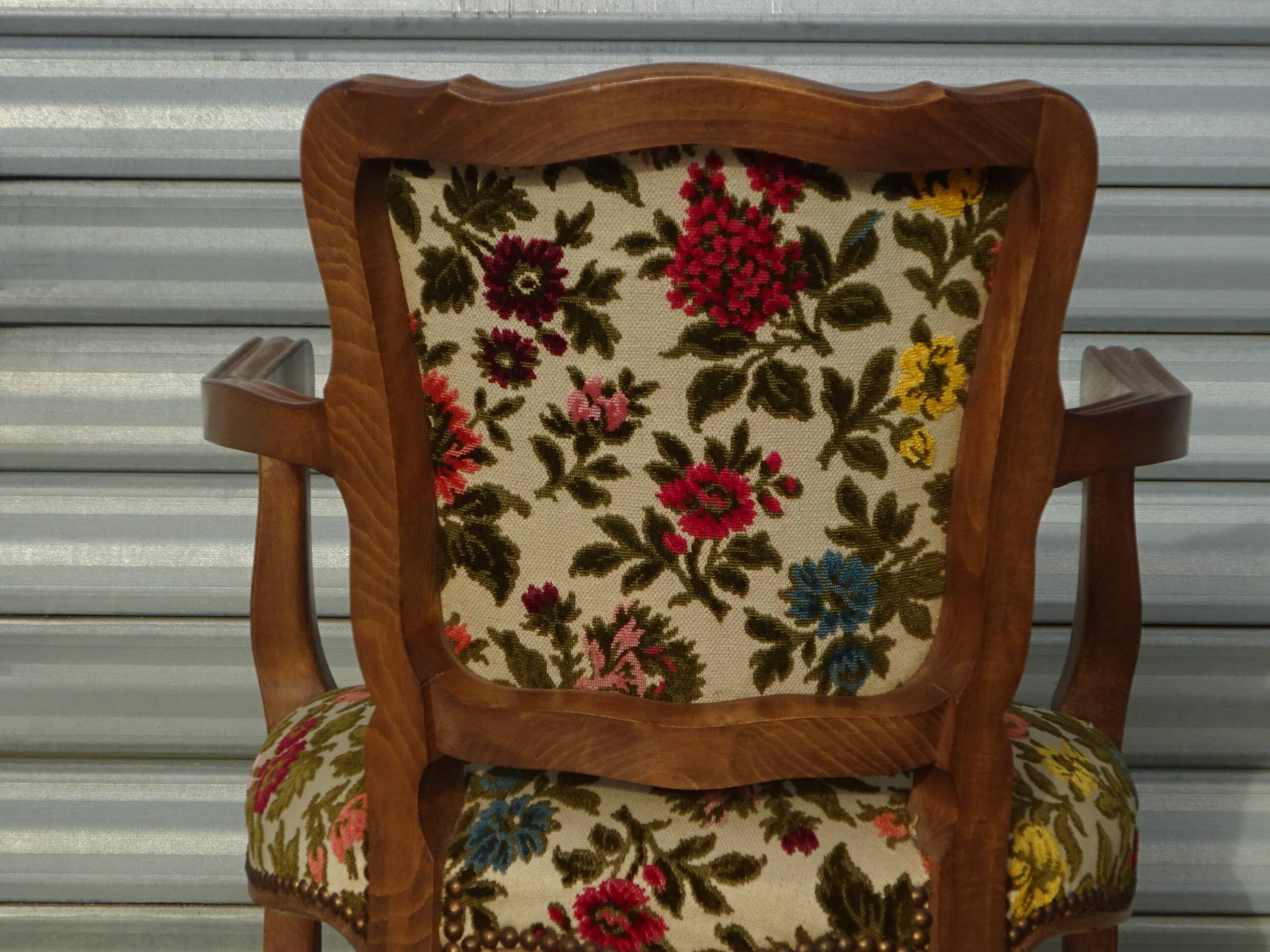 Convertible armchair with brocade fabric and floral patterns.
