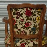 Convertible armchair with brocade fabric and floral patterns.