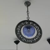 Patinated metal chandelier with cobalt blue blown glass in a rustic style.
