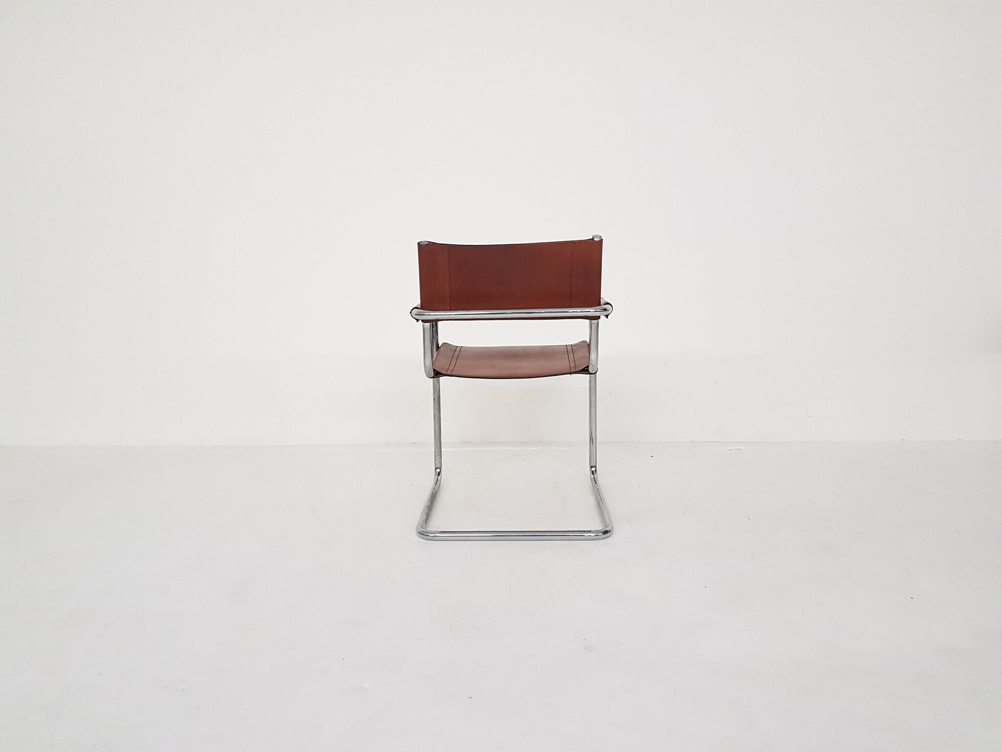 Tubular dining chair with arm rests, 1970's