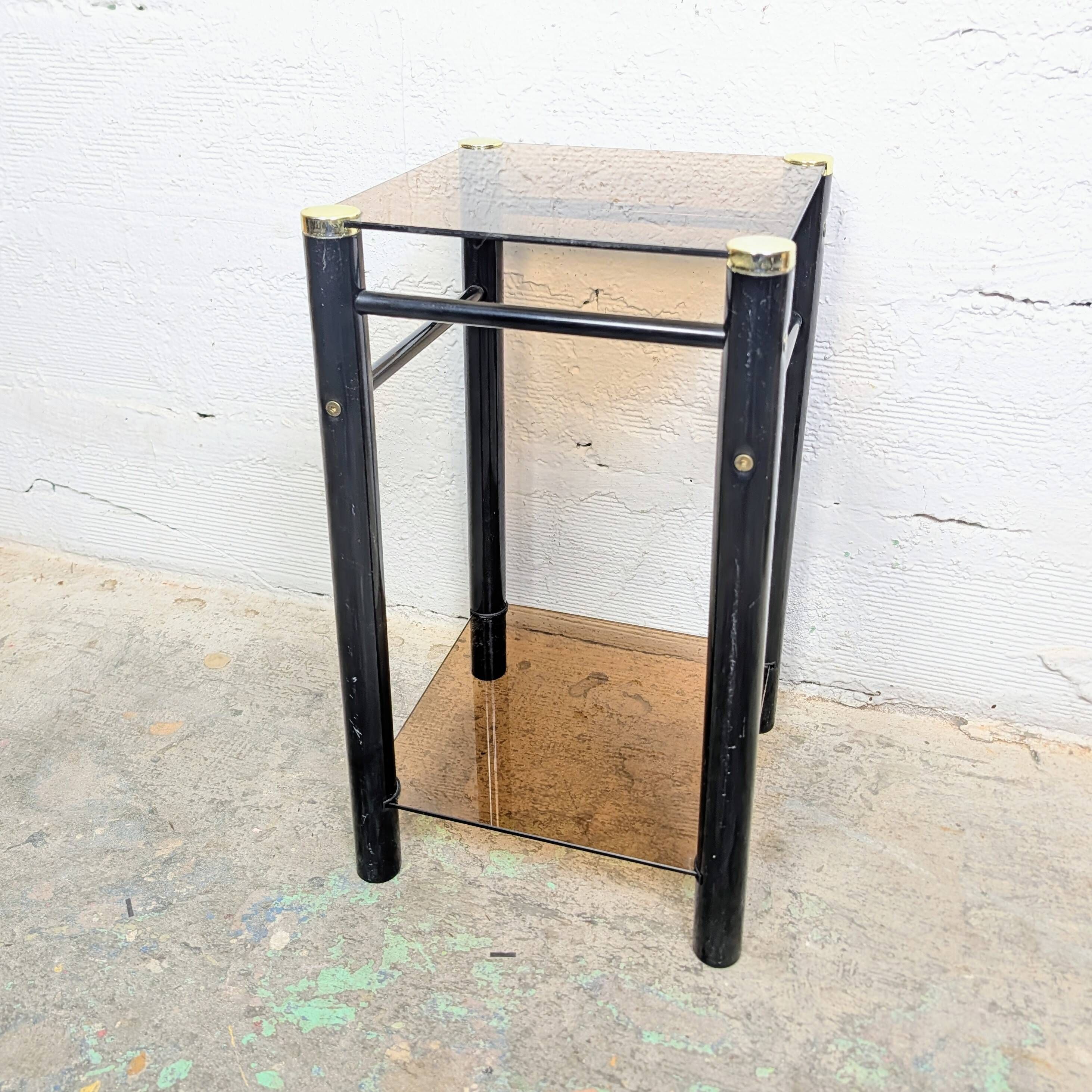 Vintage side table with two smoked glass tops and black metal.