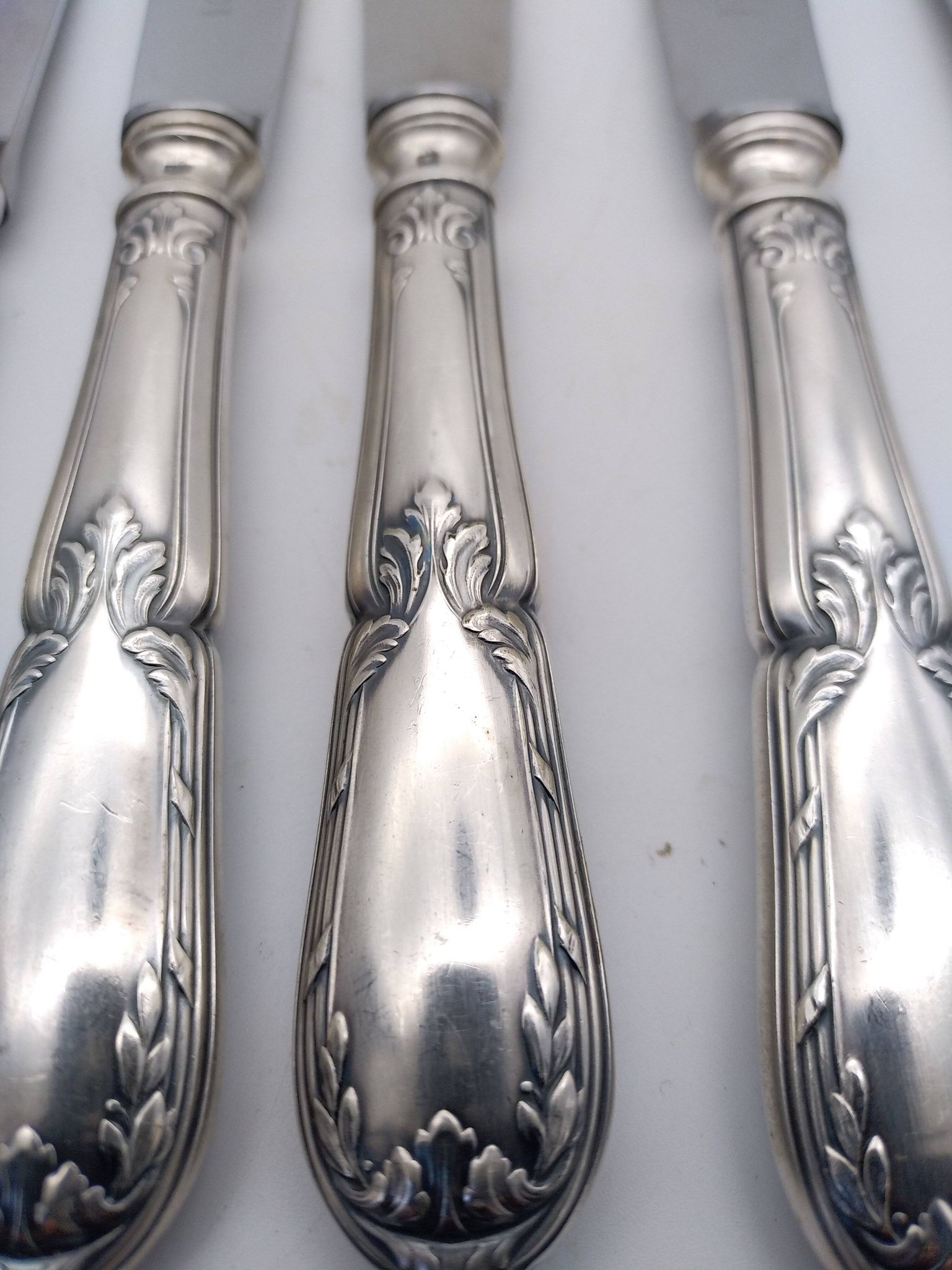 Set of 12 sfam knives in silver metal and stainless steel blades.