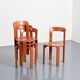Rey chairs in stained red beech by Bruno Rey