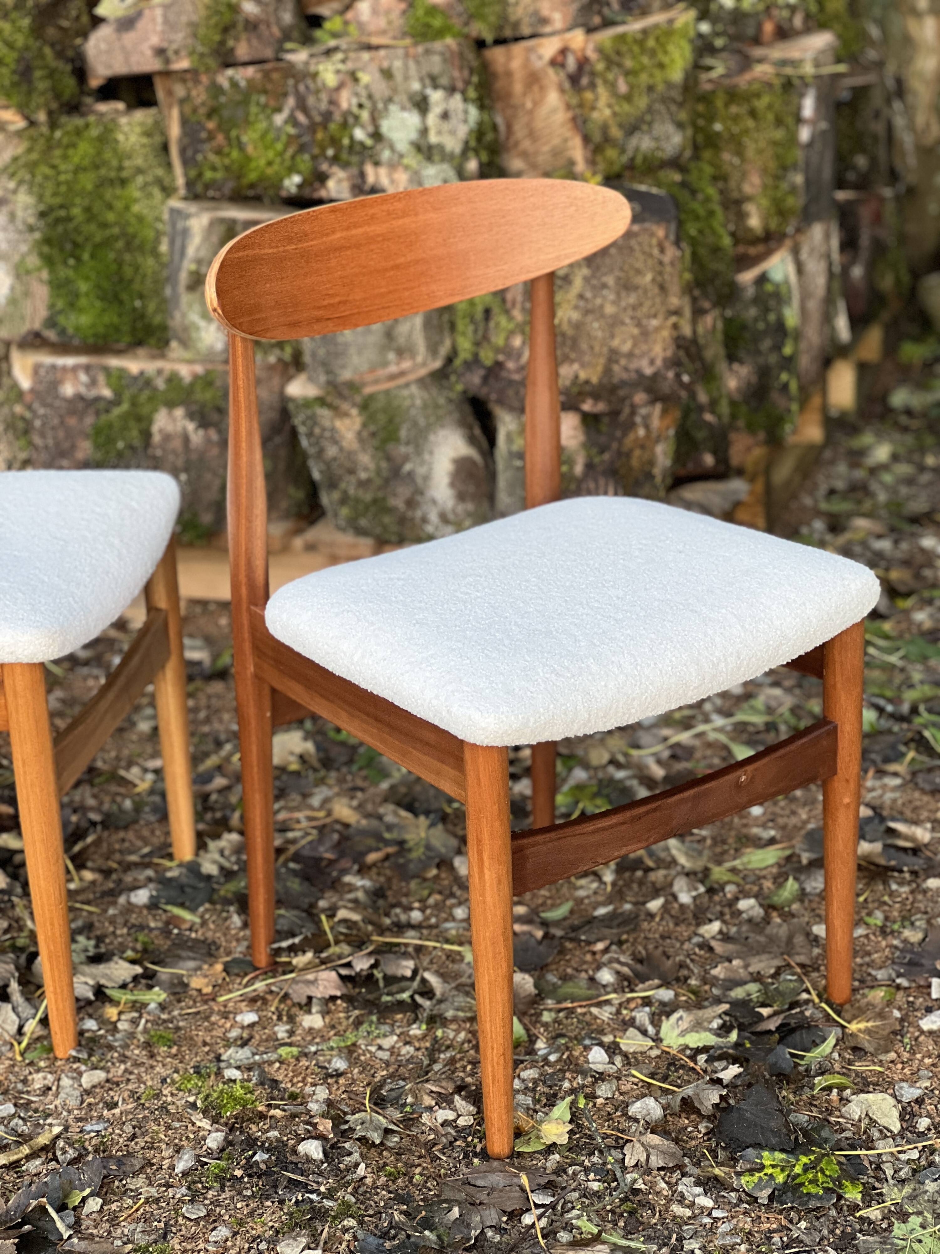 A set of GPlan chairs in teak with a white woolly fabric