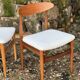 A set of GPlan chairs in teak with a white woolly fabric