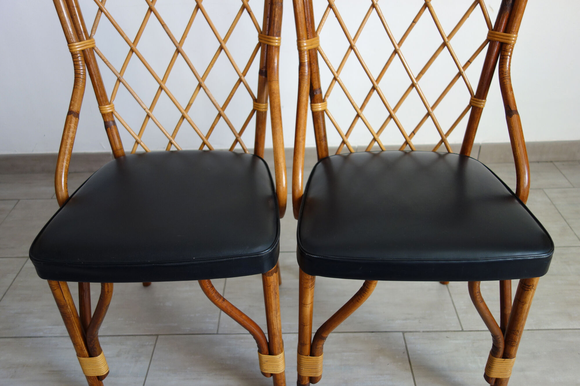 Pair of rattan and black skai bamboo chairs, 60s