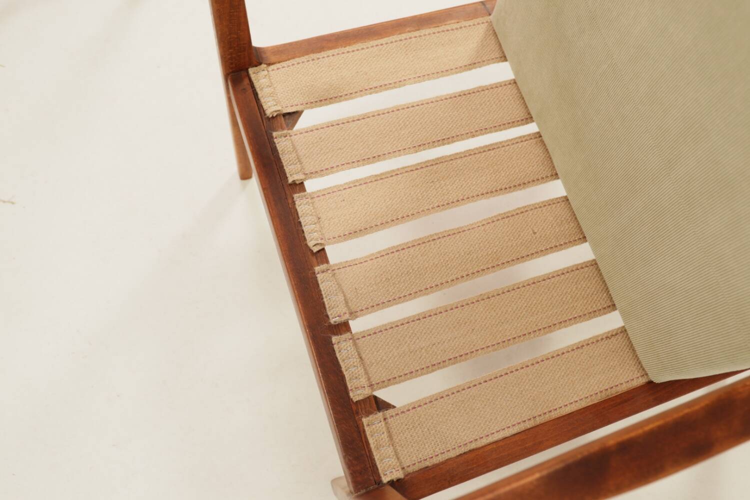 Vintage armchair in olive corduroy with a wooden frame.