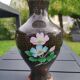 Asian handcrafted decorative vase in cloisonné enamels, neck outline & brass base