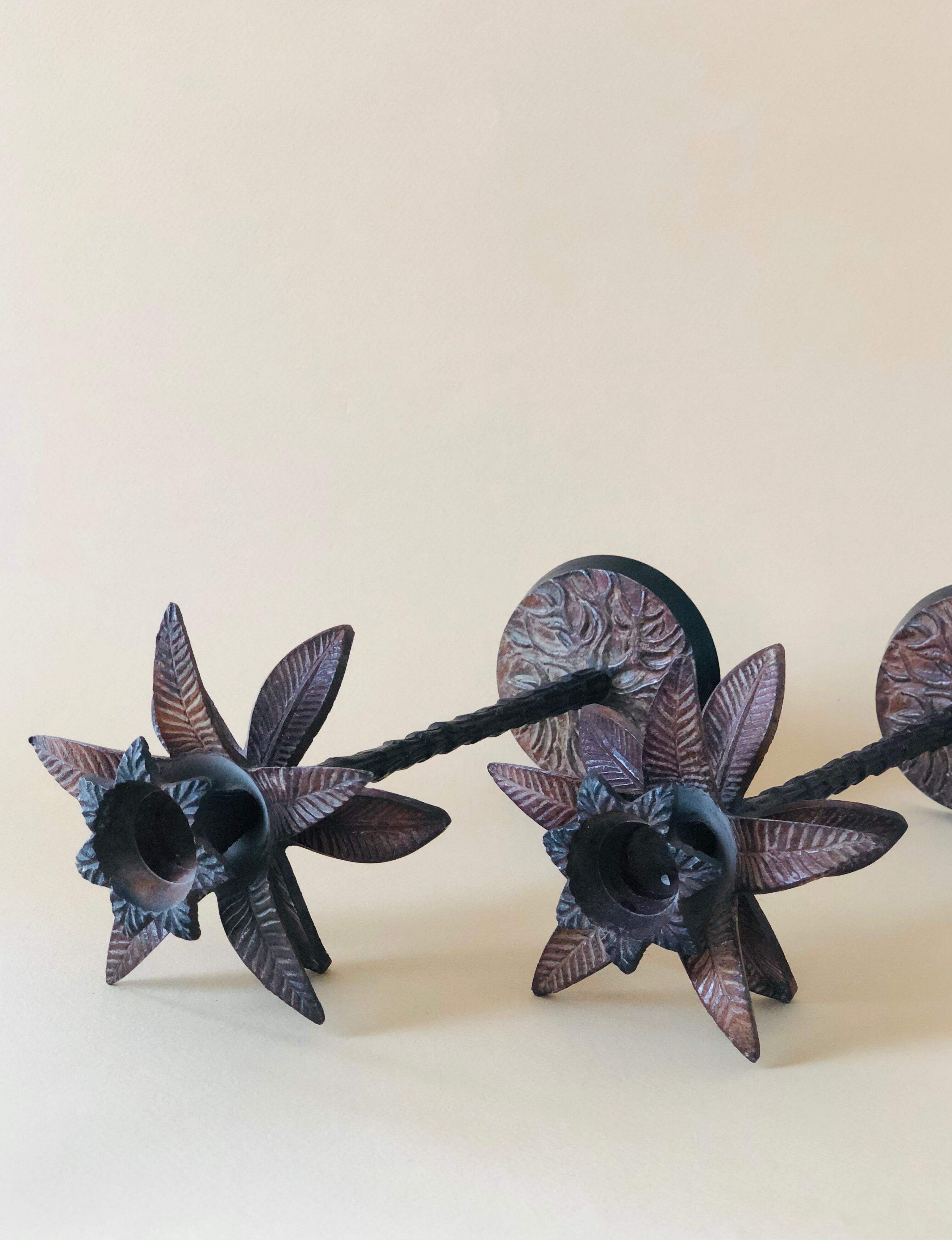 Pair of patinated metal candlesticks