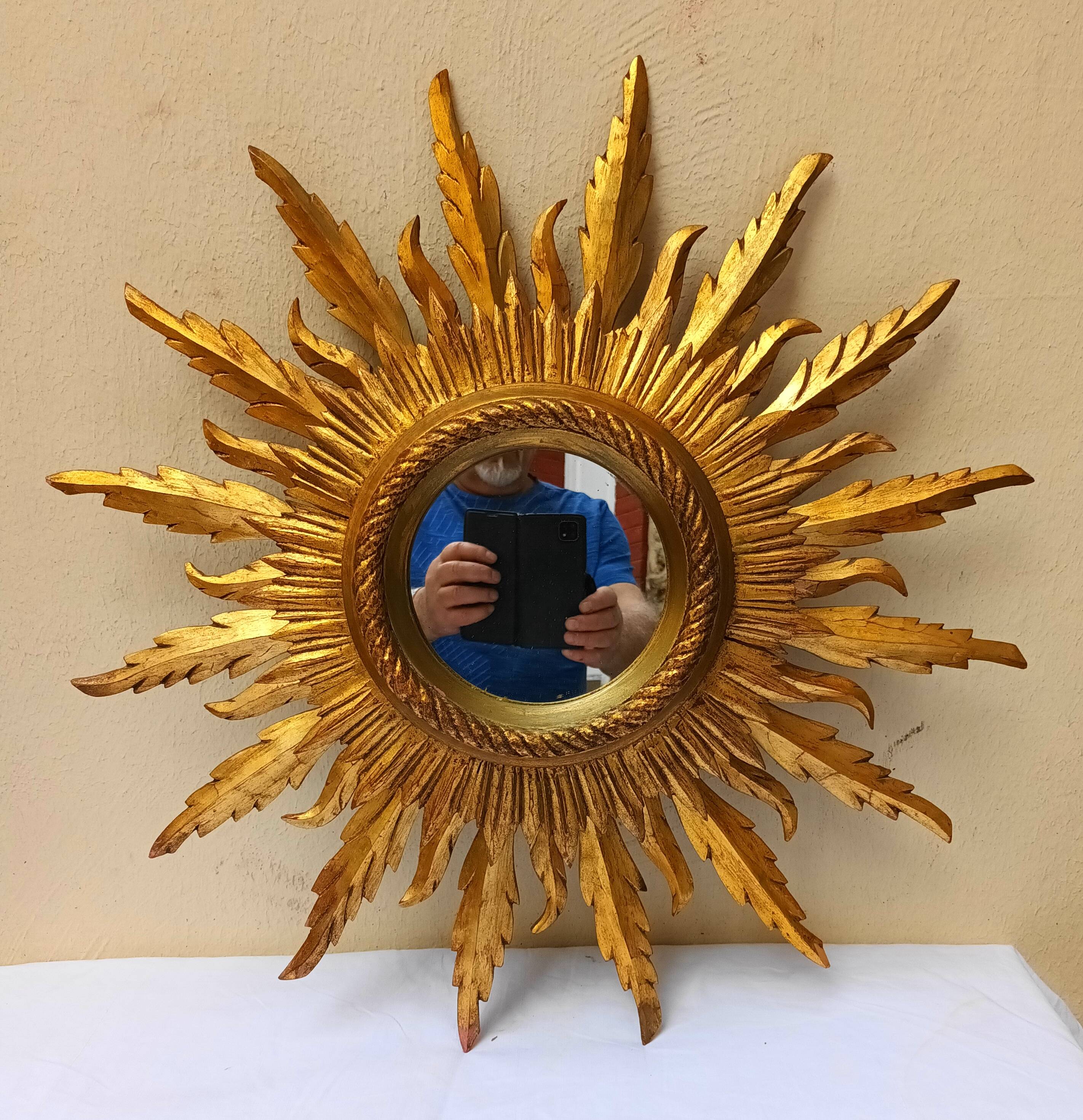 Sun mirror in carved gilded wood from the 1950s