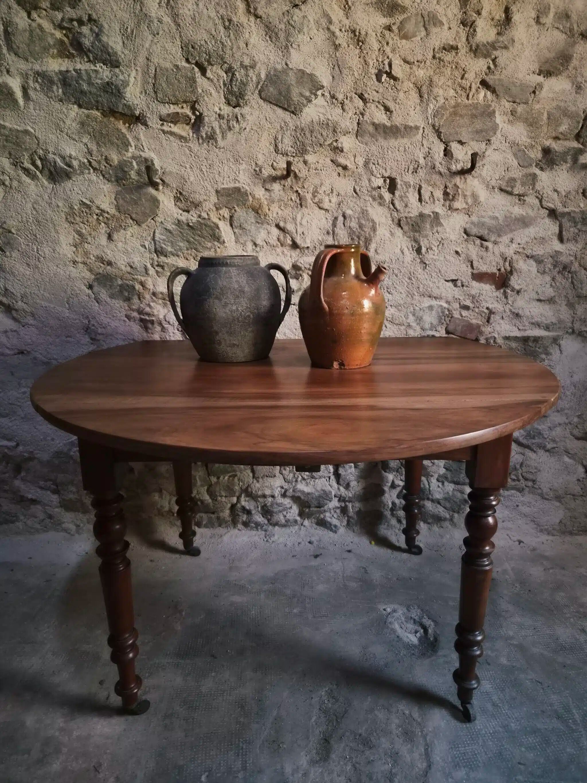 Antique drop-leaf dining table in walnut, France, circa 1900.