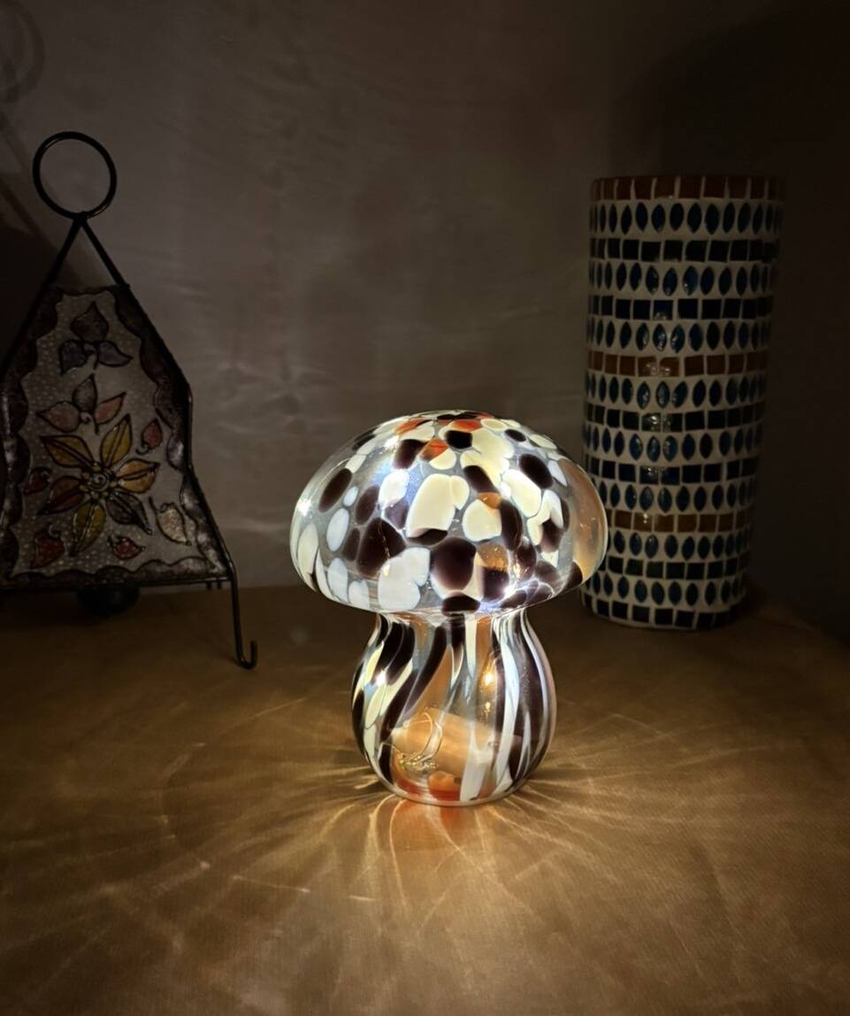 Mosaic glass mushroom lamp in black, white, and amber.