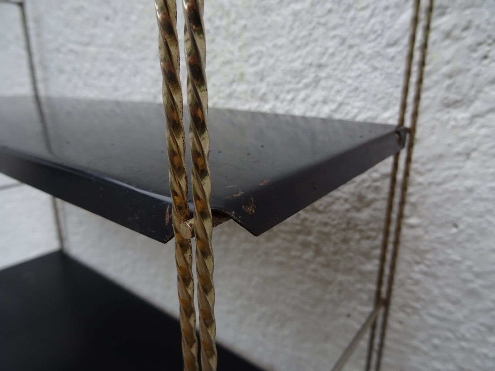Metal thong wall shelf