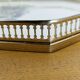 Vintage service tray with a golden gallery and mirror, decorated with ducks.