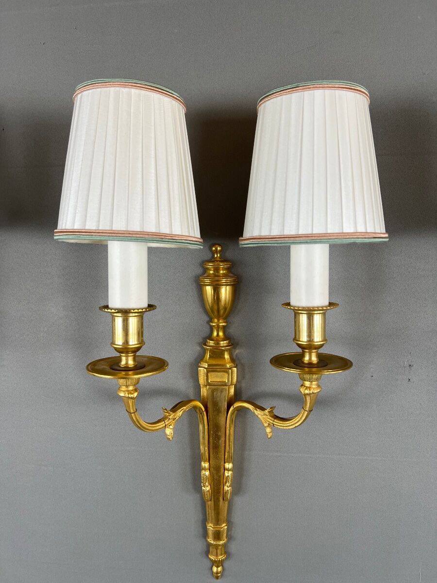 Set of three Louis XVI style wall sconces in gilded bronze, 20th century.