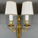 Set of three Louis XVI style wall sconces in gilded bronze, 20th century.