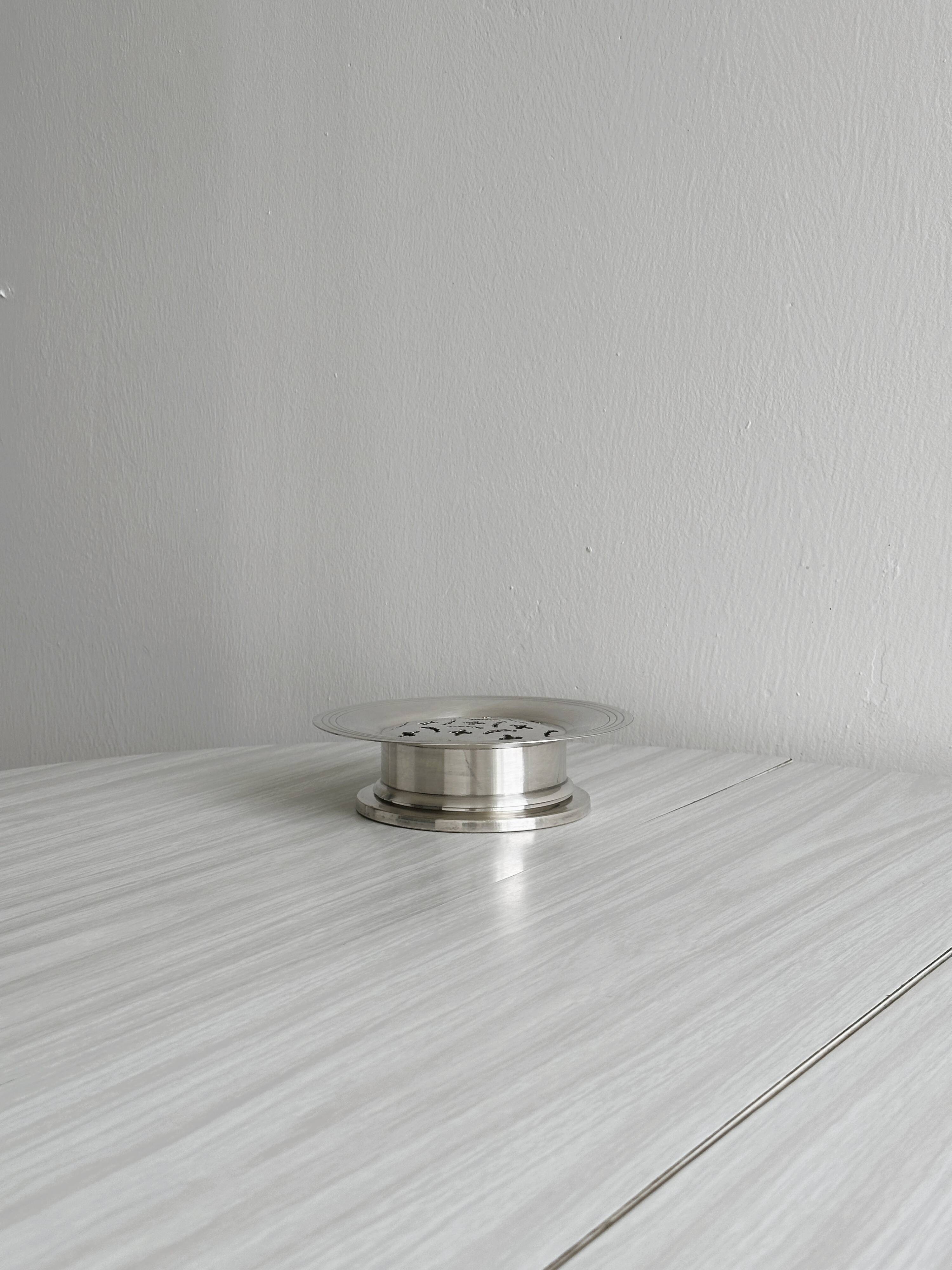 Antique butter dish in shiny metal