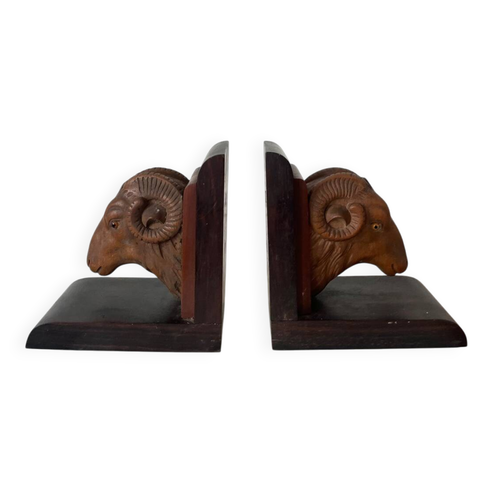 Pair of carved wooden bookends in the shape of ram's heads.