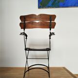 Folding garden chair with teak slats on a wrought iron structure