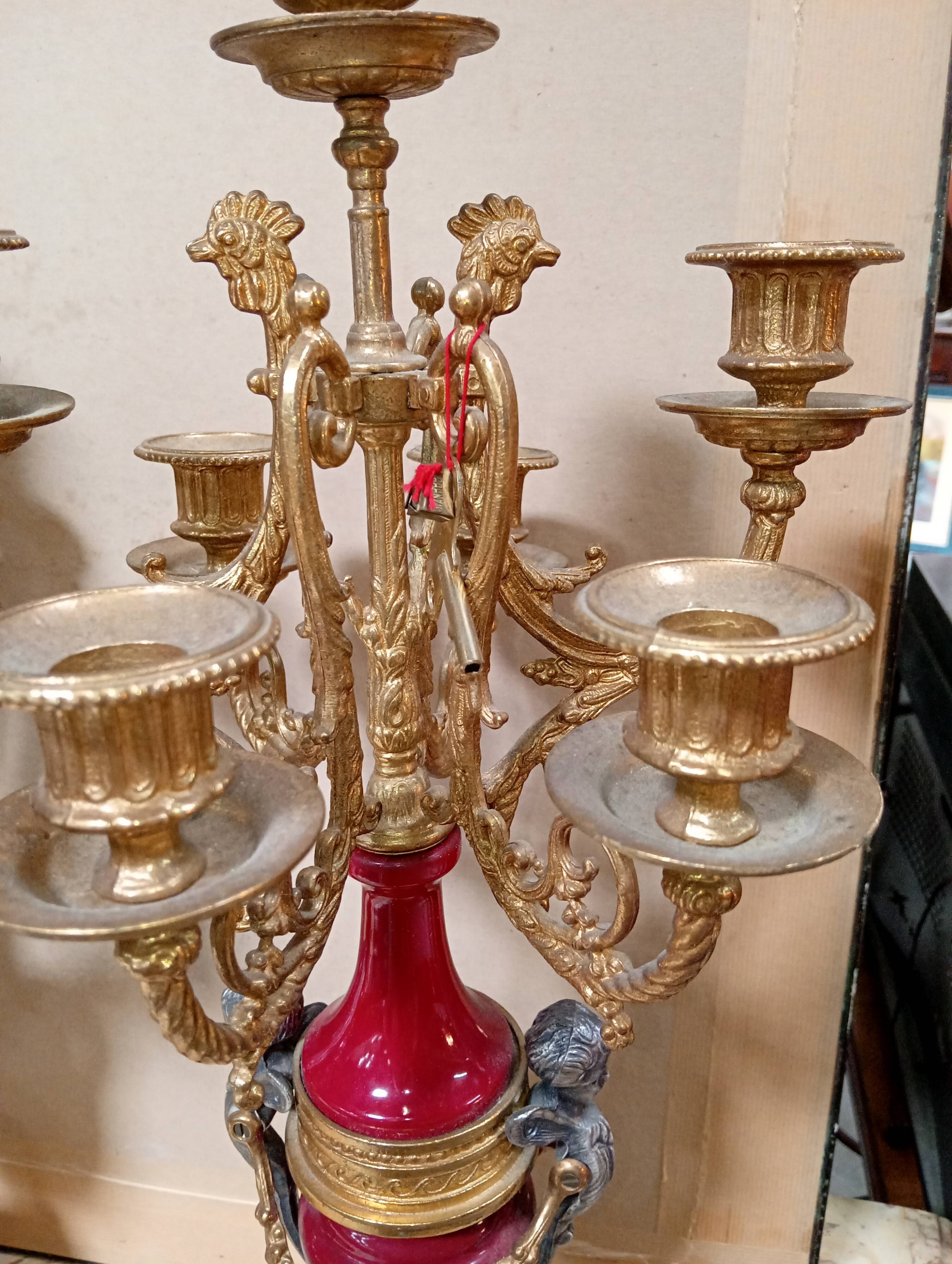 Pair of six-light candelabra in patinated and gilded bronze and spelter.