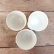 Three antique cups decorated with fleur-de-lis.