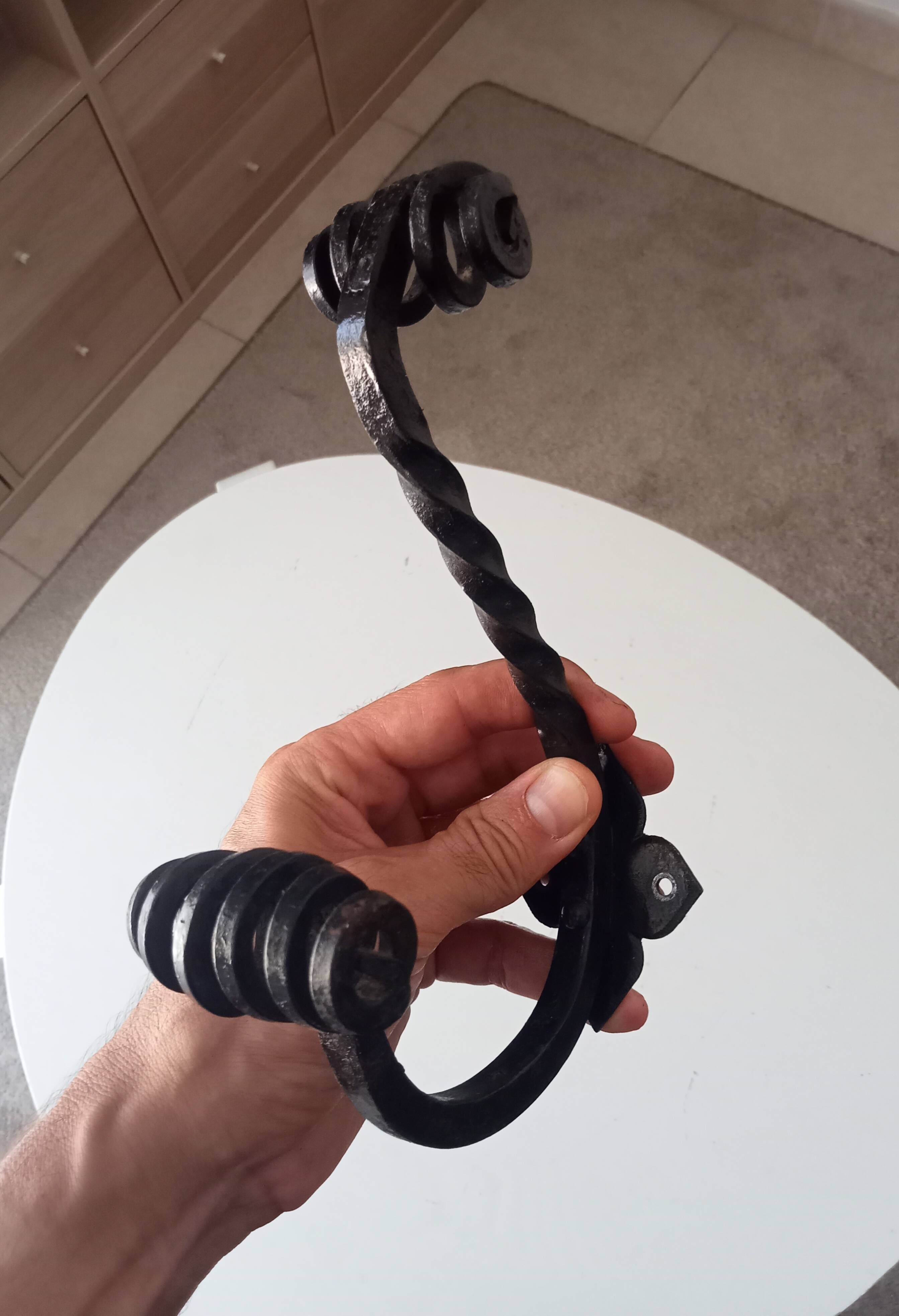 Brutalist wall coat rack in wrought iron.