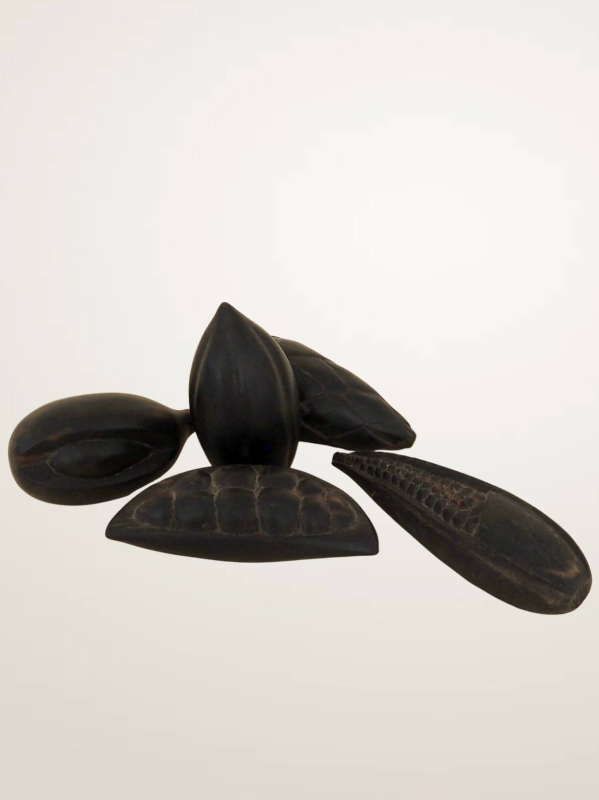 Set of decorative fruits in carved blackened wood.