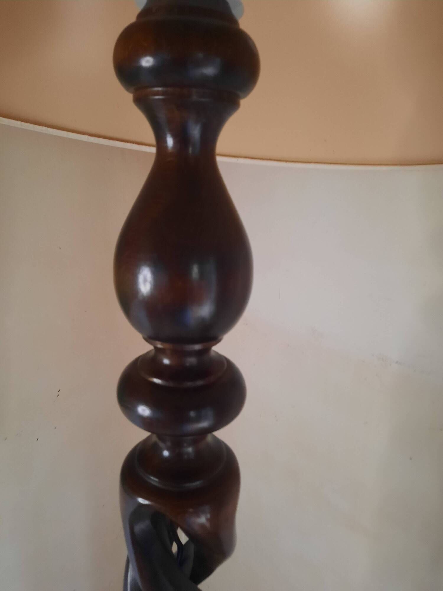 Sculptural floor lamp made of twisted turned wood.