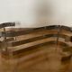Oval coffee table in chrome metal and smoked glass, S-shape.