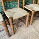 Set of 4 solid wood chairs with straw seats.