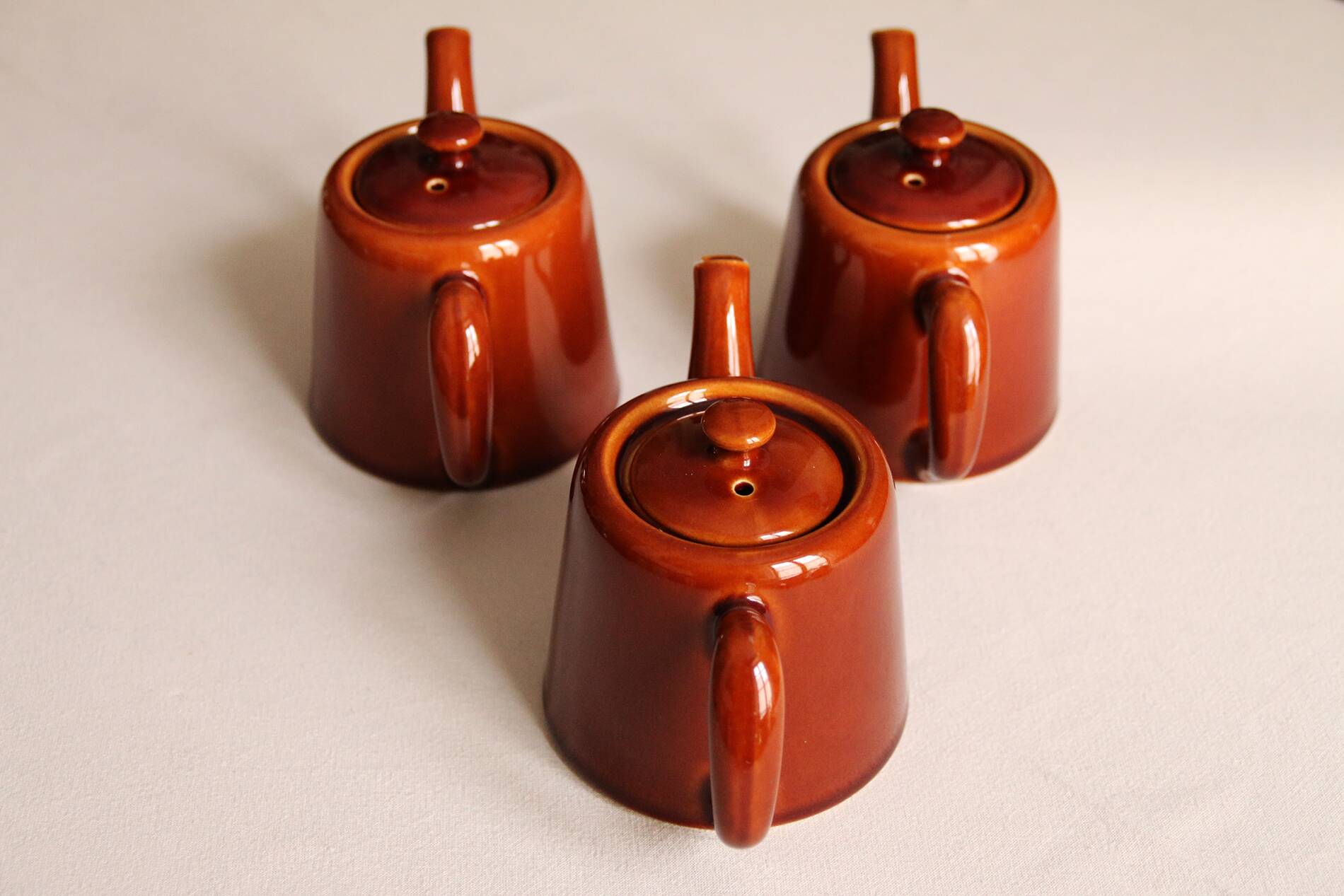 3 brown glazed ceramic teapots