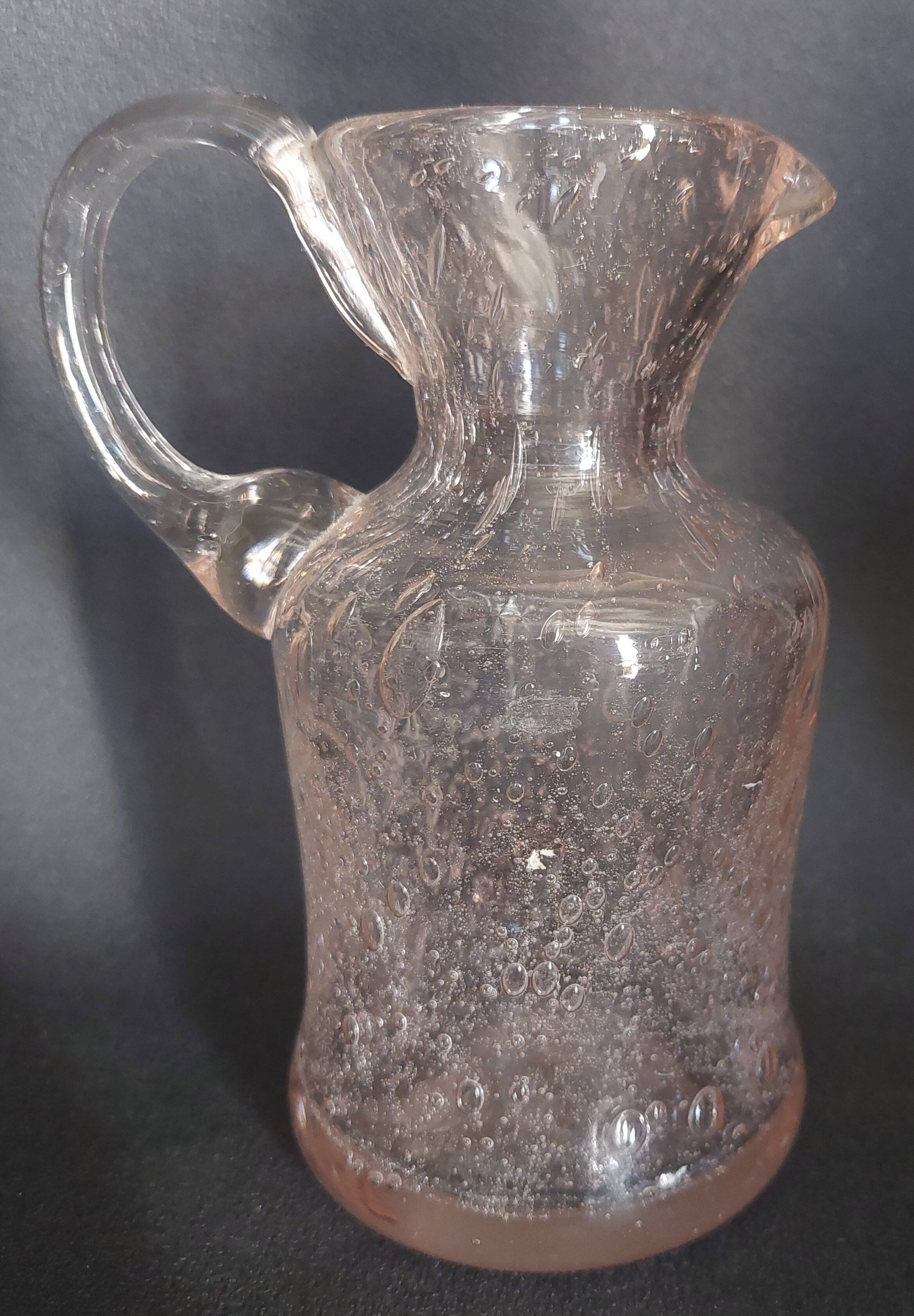 Small blown glass pitcher with bubbles from the 20th century.
