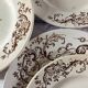 4 assiettes plates en terre de fer marron à décor d'oiseaux